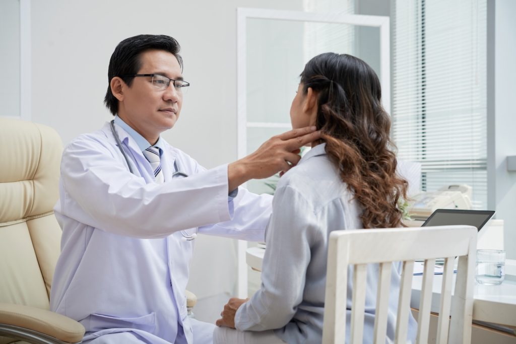 A doctor taking care of a patient during a routine appointment.